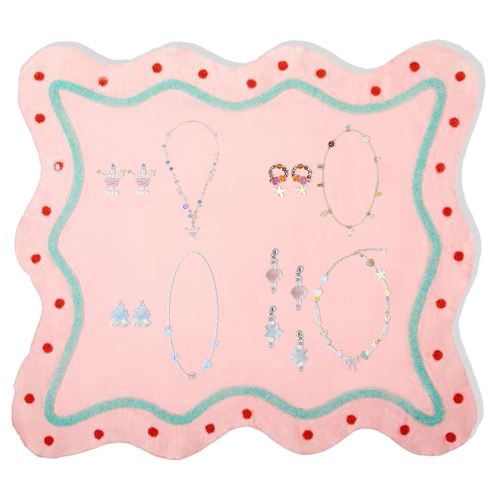 Fullice earrings and necklace sets arranged across a playful pink jewelry display