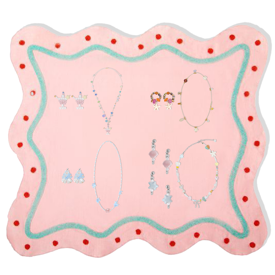 Fullice earrings and necklace sets arranged across a playful pink jewelry display