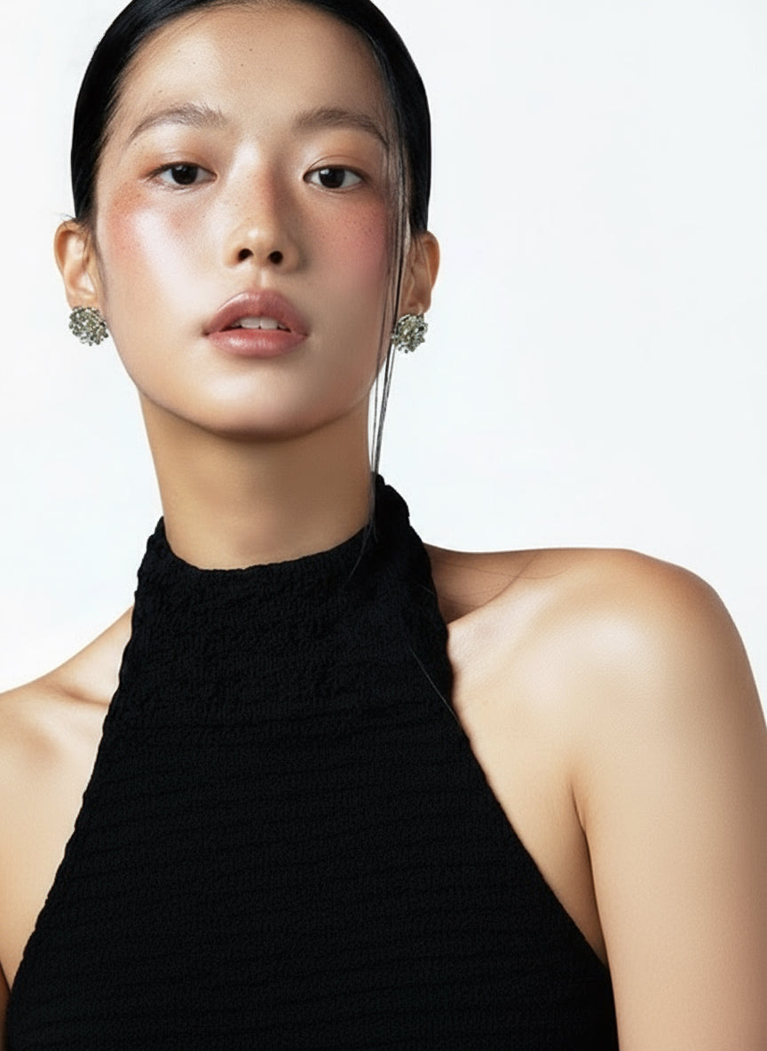 Model in a black halter top wearing compact colorful Fullice beaded stud earrings