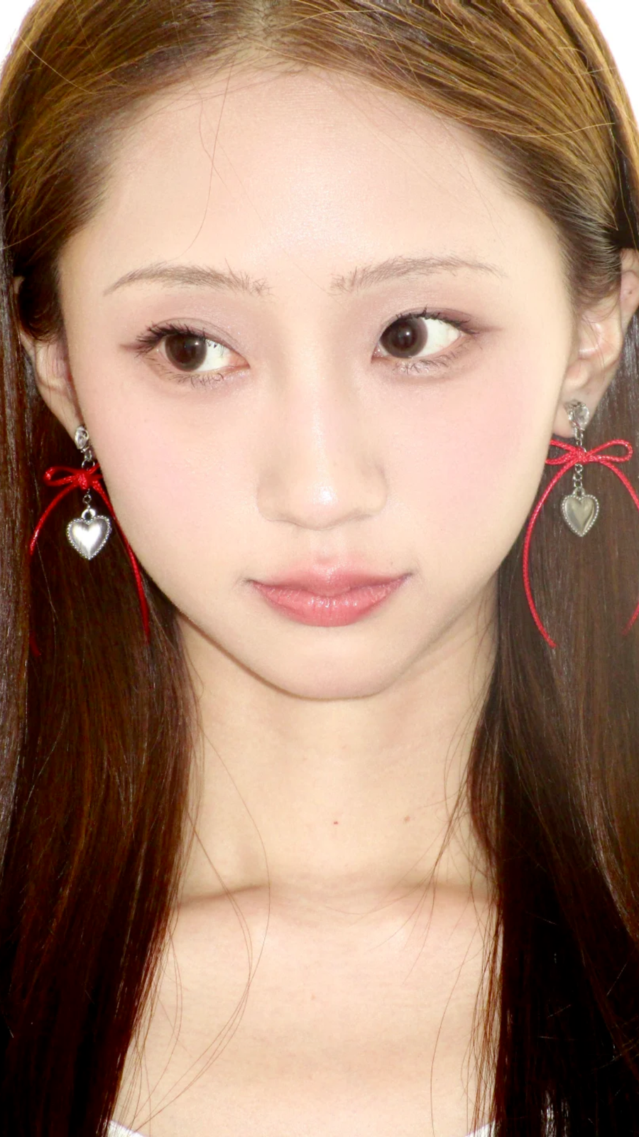 Model wearing long red Fullice bow earrings with a simple neutral outfit